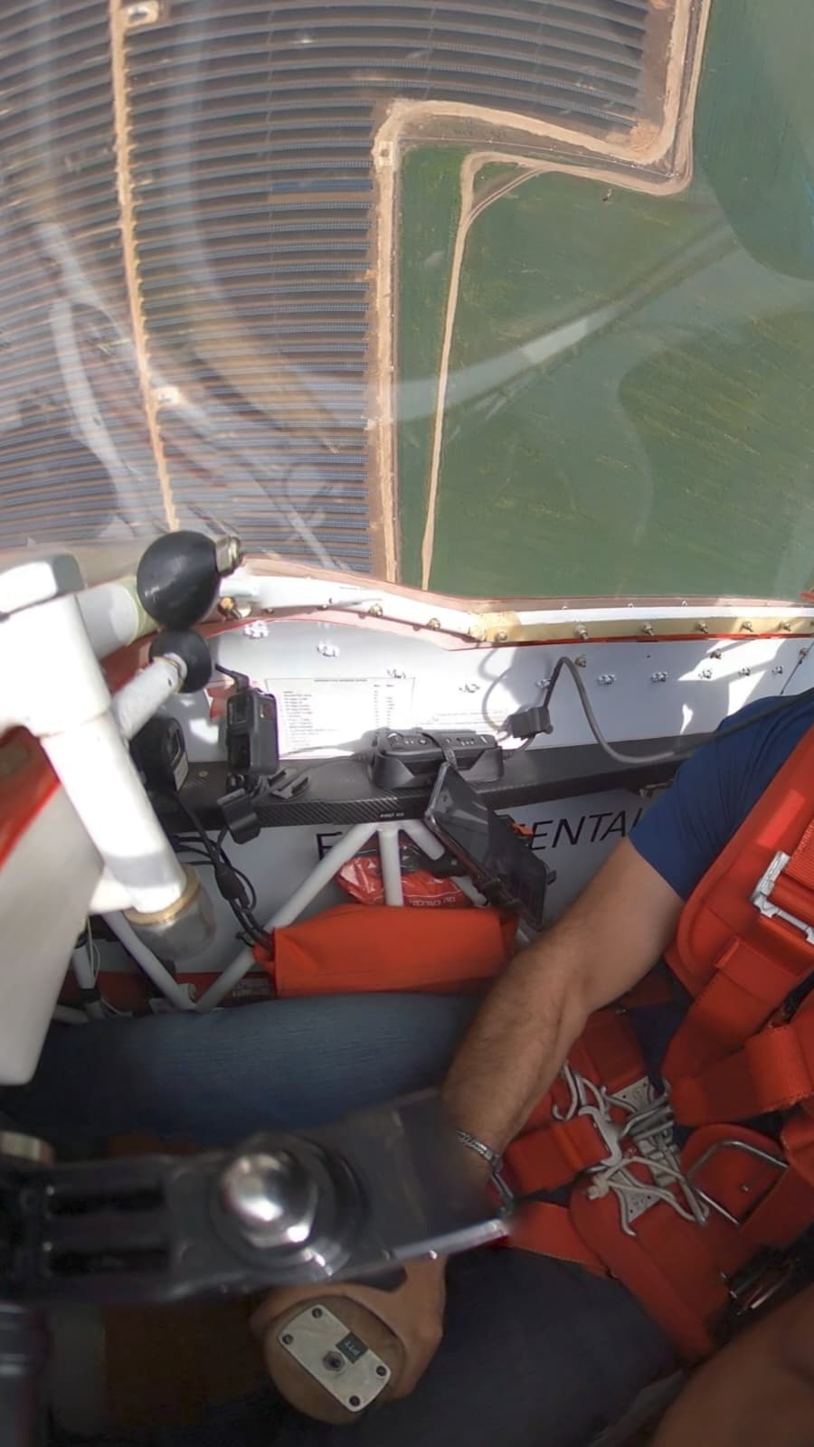 Bose headset controller secured in its cockpit mount during an aerobatic flight